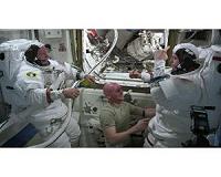 Station Crew Checks Out Spacesuits, Conducts Research