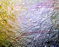 Unusual Red Arcs Spotted on Icy Saturn Moon