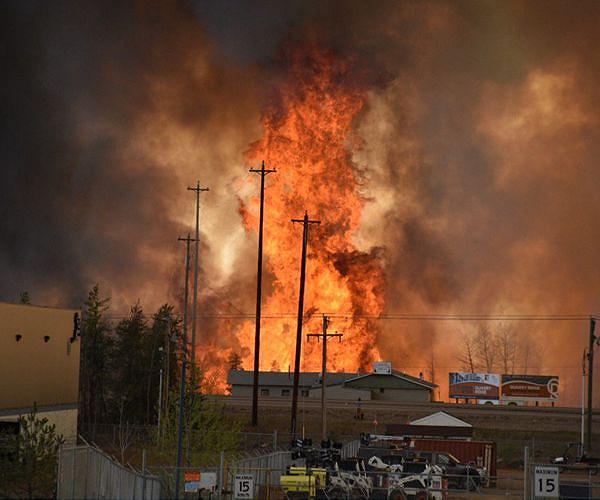 Threat from massive western Canada wildfire eases; Winds complicate wildfire battle in Spain