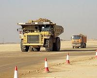 Oil inches lower on Caterpillar, weak jobs report