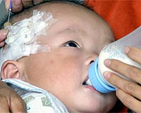 China reluctant to reveal tainted milk figures