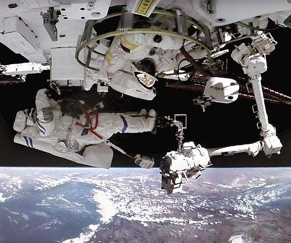 Spacewalk completes repairs, marks milestone for young astronaut