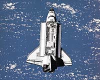 Shuttle undocks from space station, heads home
