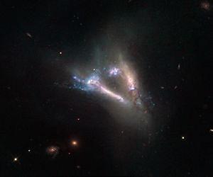Hubble Sees Cosmic Flying V of Merging Galaxies