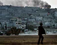Kurds hold out in Syria's Kobane one month into IS assault