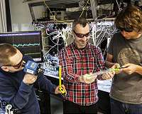 Quantum entanglement between a single photon and a trillion of atoms