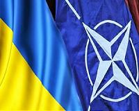 Merkel, in Ukraine, vows to uphold Russia sanctions