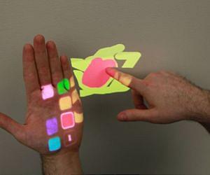 Wearable depth-sensing projection system makes any surface capable of multitouch interaction