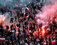 Youths in military uniform march through Warsaw on Soviet invasion anniversary