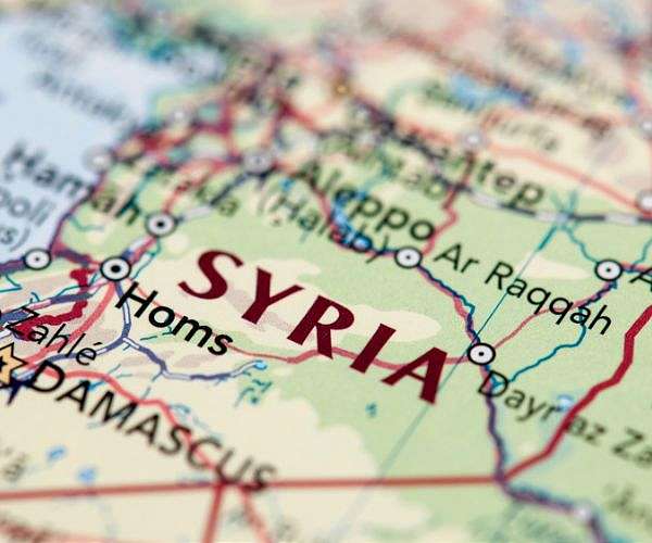 New Syria leader, in US, plays down Israel normalization
