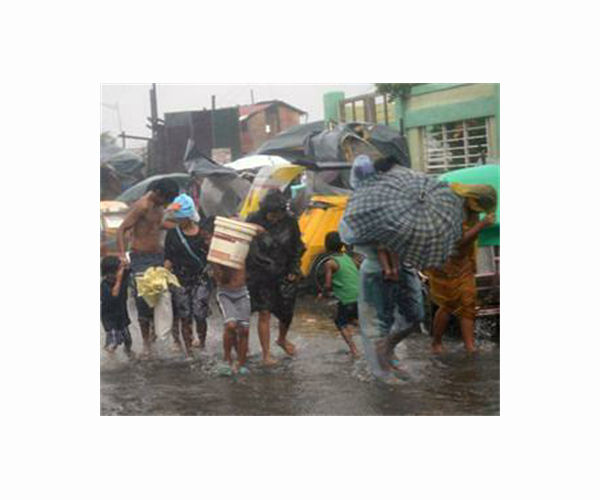 Eight dead in Philippine floods as thousands flee homes