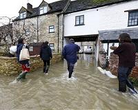 Storms, high winds batter flooded parts of Britain