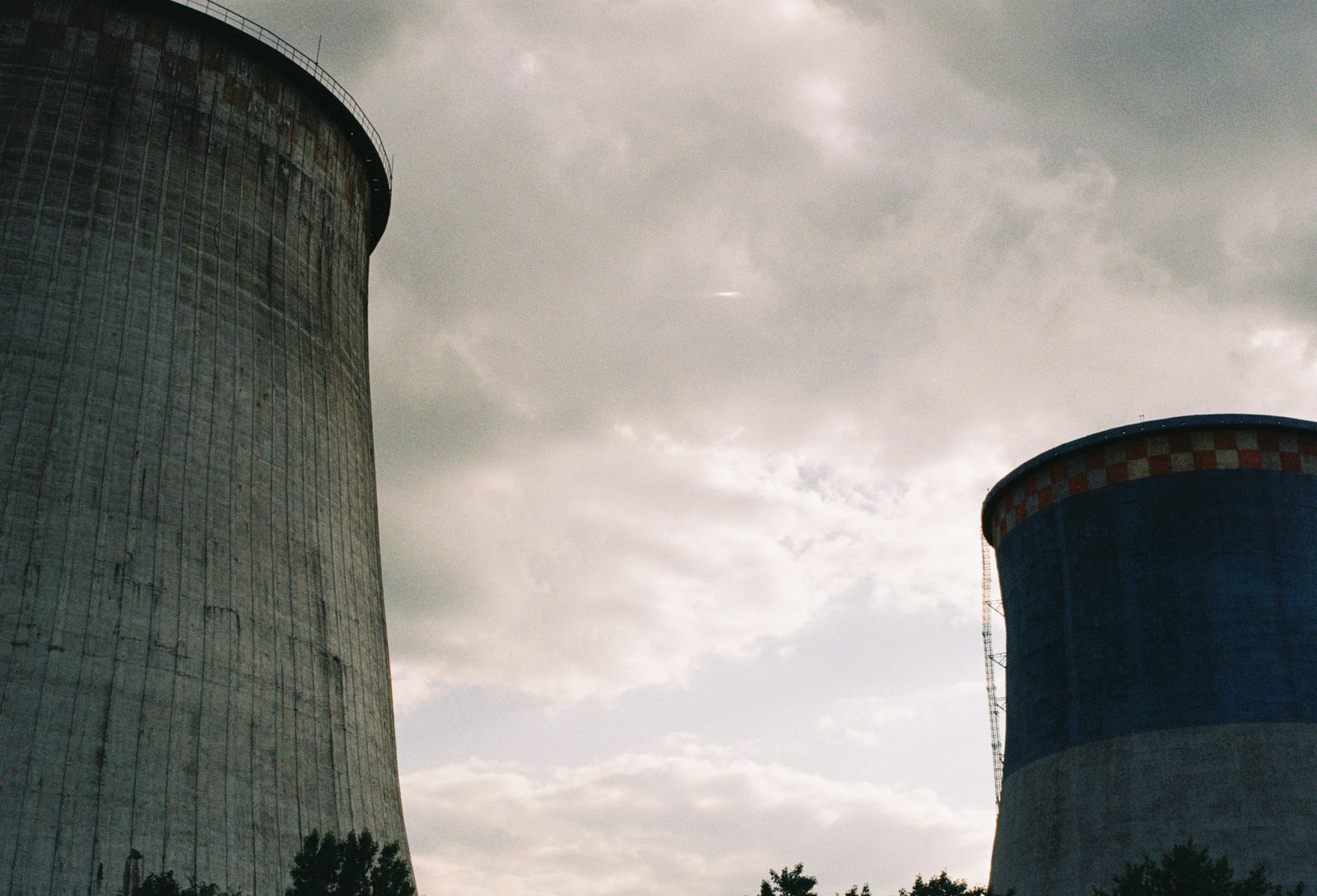 A single uranium-235 nucleus splitting releases about 200 million electron volts, roughly 50 million times the energy of burning one carbon atom, which is why a fuel assembly the size of a car can power a city for eighteen months