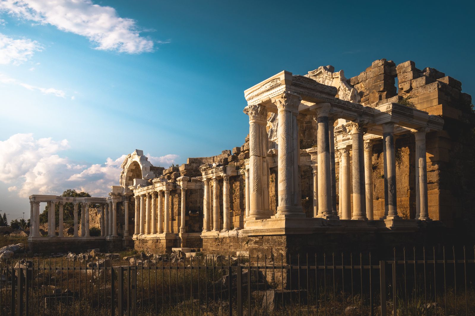 How does a two-thousand-year-old harbour concrete, poured by engineers of a Mediterranean empire, keep growing stronger in seawater while modern Portland cement crumbles in the same conditions within decades?